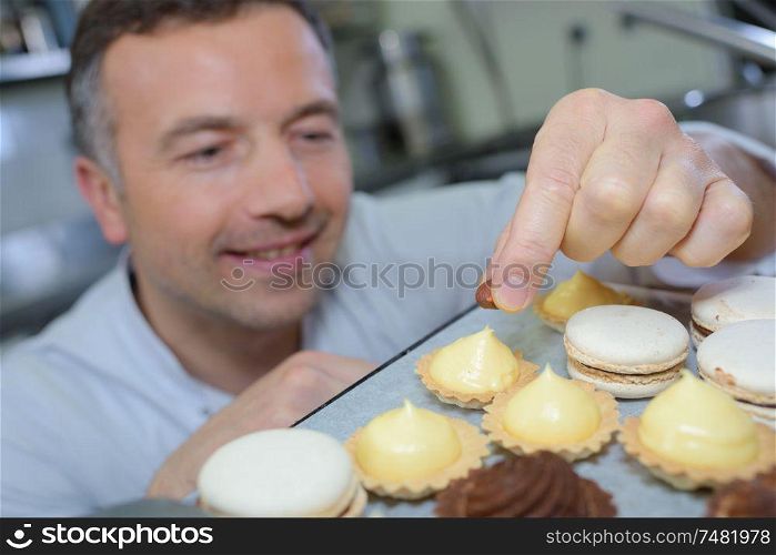 portrait of chef decorating confectionery