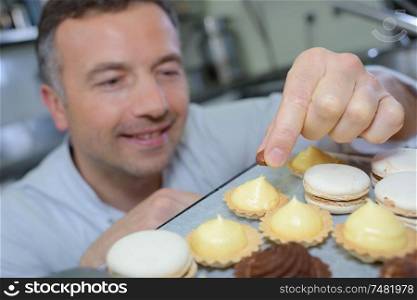 portrait of chef decorating confectionery