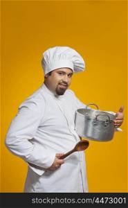 Portrait of chef holding utensil and spoon