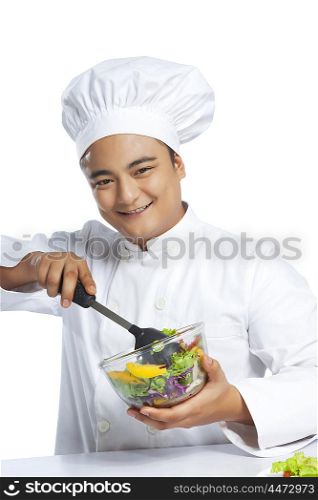 Portrait of chef mixing vegetables in bowl