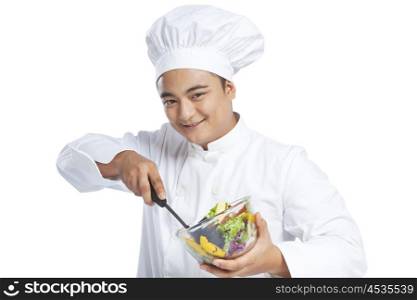 Portrait of chef mixing vegetables in bowl