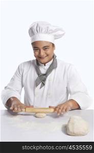 Portrait of chef rolling dough