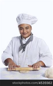 Portrait of chef rolling dough