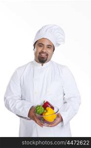 Portrait of chef with bowl of capsicum