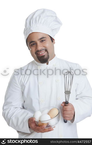 Portrait of chef with bowl of eggs