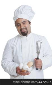 Portrait of chef with bowl of eggs