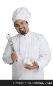 Portrait of chef with bowl of eggs