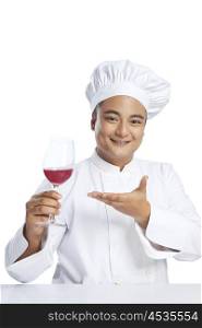 Portrait of chef with glass of wine