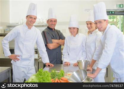 Portrait of chef with his student chefs