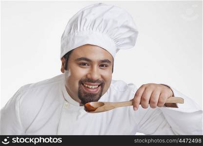 Portrait of chef with wooden spoon smiling