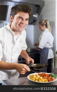 Portrait Of Chef Working In Restaurant Kitchen