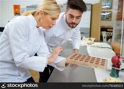 portrait of chefs with chocolate molds