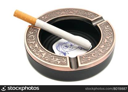 portrait of child and cigarette in ashtray