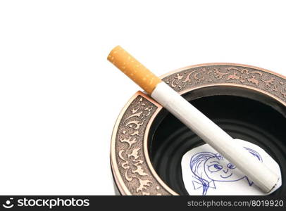 portrait of child and cigarette in ashtray closeup