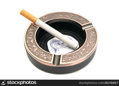 portrait of child and cigarette in ashtray on white