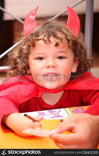 Portrait of child dressed up as devil