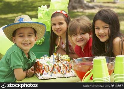 Portrait of children at a birthday party in a park