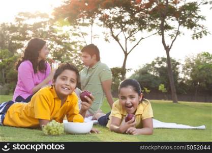 Portrait of children eating fruit