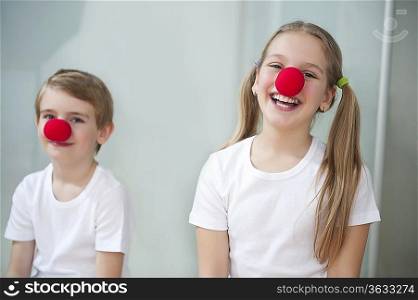 Portrait of children wearing clown noses