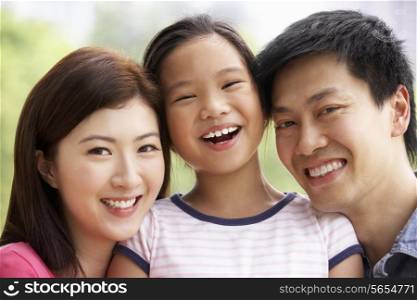 Portrait Of Chinese Family With Daughter In Park