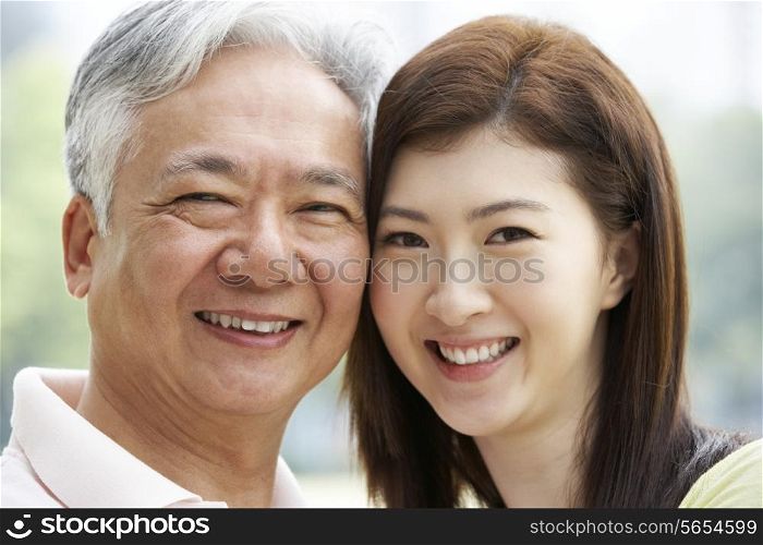 Portrait Of Chinese Father With Adult Daughter In Park