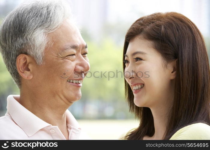 Portrait Of Chinese Father With Adult Daughter In Park