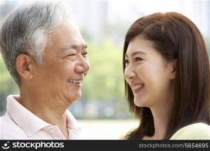 Portrait Of Chinese Father With Adult Daughter In Park