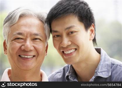 Portrait Of Chinese Father With Adult Son In Park
