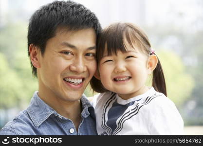 Portrait Of Chinese Father With Daughter In Park