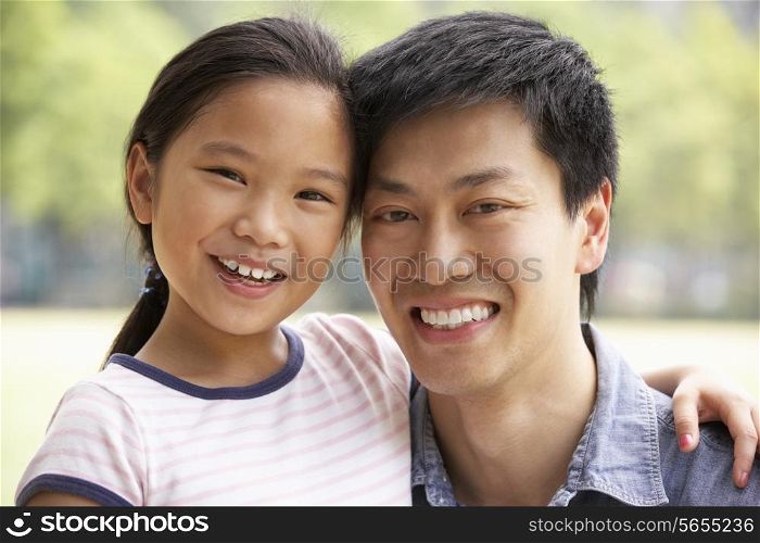 Portrait Of Chinese Father With Daughter In Park