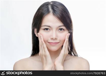 Portrait of Chinese woman with hands touching face, skincare concept