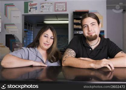 Portrait of co-workers at work in copy center