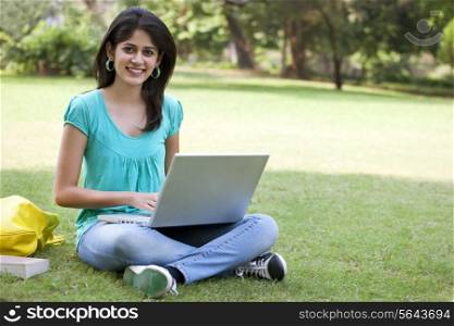 Portrait of college student using laptop