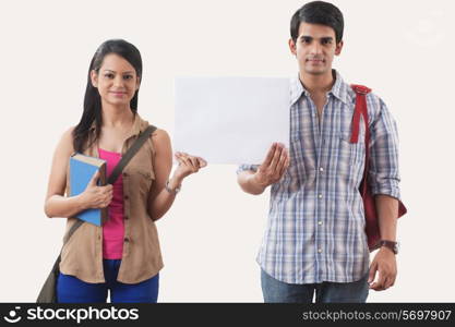 Portrait of college students holding a white board