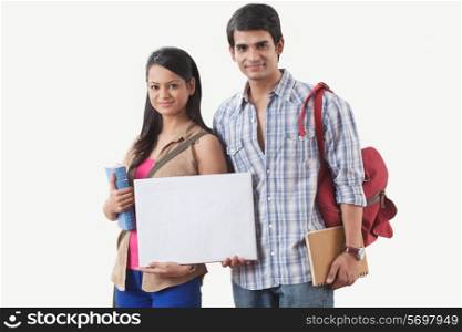Portrait of college students holding a white board