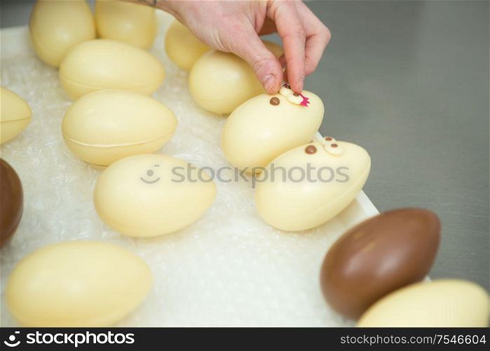 portrait of confectioner decorating chocolate eggs