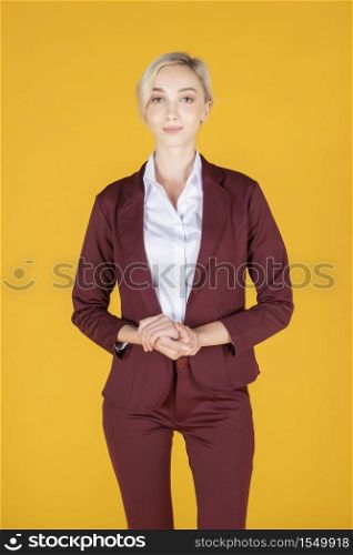 Portrait of confidence caucasian business woman on yellow background