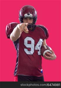 portrait of confident American football player. portrait of confident American football player holding ball isolated on colorful background