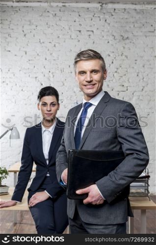 Portrait of confident business colleagues standing at office