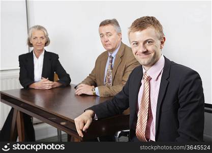 Portrait of confident business group at desk in office
