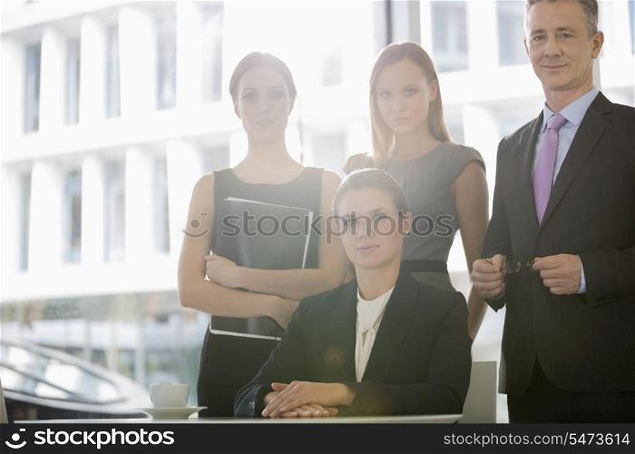 Portrait of confident business people in office cafeteria