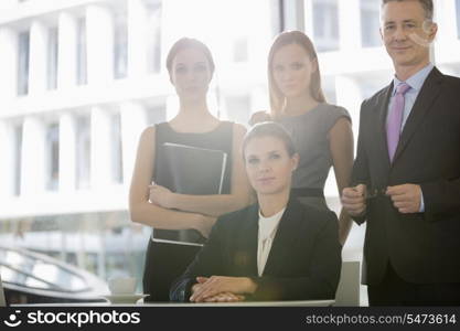 Portrait of confident business people in office cafeteria