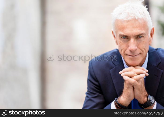 Portrait of confident businessman outdoors. Portrait of confident businessman in suit outdoors