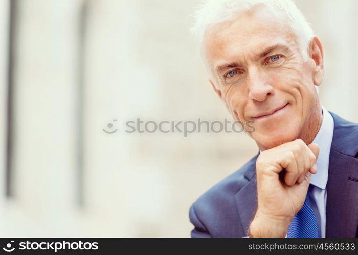 Portrait of confident businessman outdoors. Portrait of confident businessman in suit outdoors