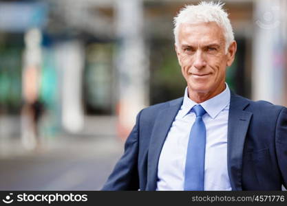 Portrait of confident businessman outdoors. Portrait of confident businessman in suit outdoors