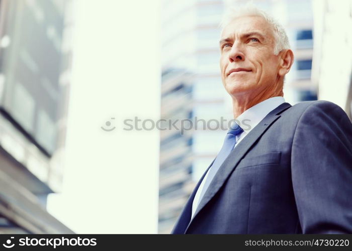 Portrait of confident businessman outdoors. Portrait of confident businessman in suit outdoors