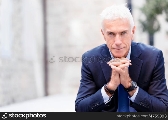 Portrait of confident businessman outdoors. Portrait of confident businessman in suit outdoors