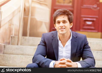 Portrait of confident businessman outdoors. Portrait of confident businessman with his mobile phone outdoors