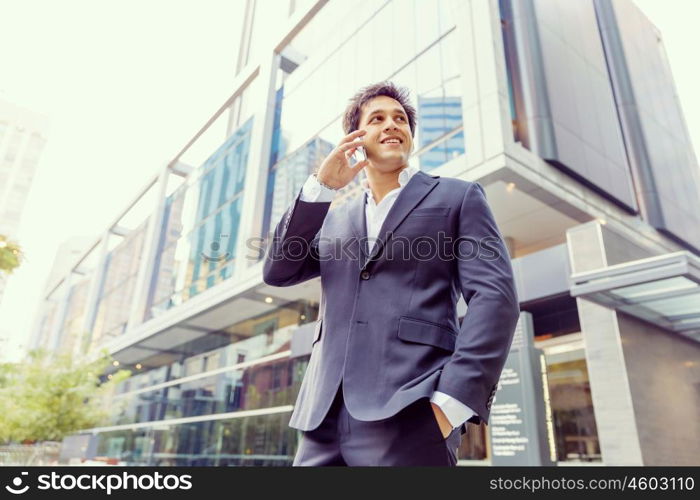 Portrait of confident businessman outdoors. Portrait of confident businessman with his mobile phone outdoors