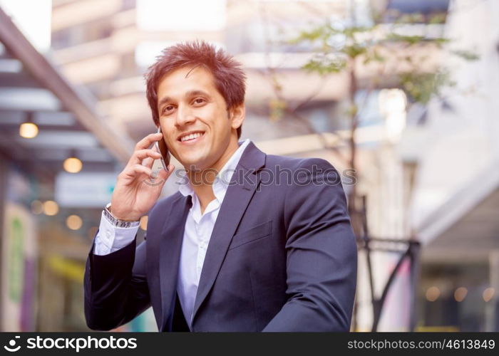 Portrait of confident businessman outdoors. Portrait of confident businessman with his mobile phone outdoors